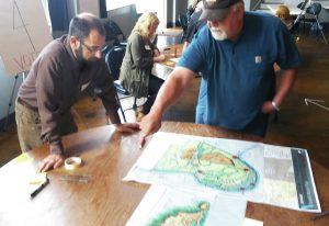 Courtesy of The Daily Herald. Equinox' David Tuch works with community member at design charrette